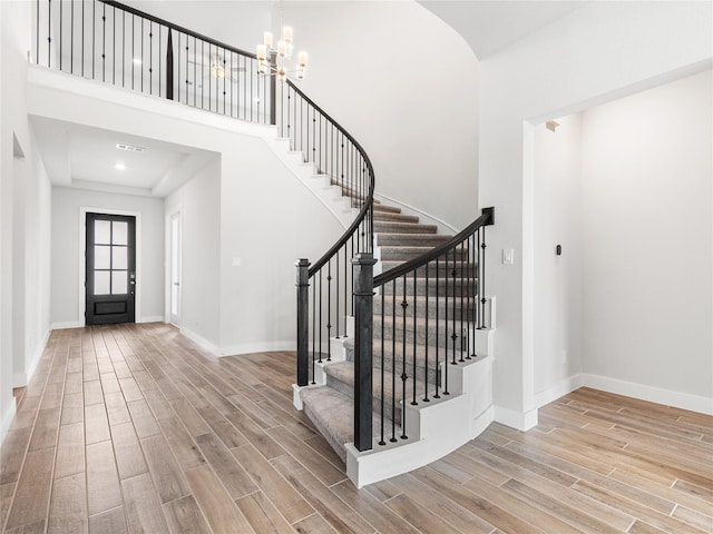 10903 Providence Ct, Missouri City, TX 77459 - foyer featuring wood finished floors, stairs, a chandelier, and a high ceiling