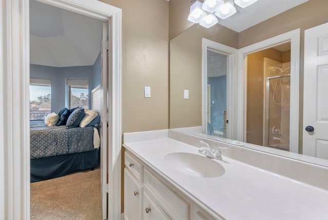 bathroom with walk in shower and vanity