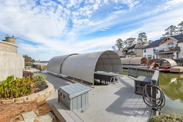 exterior space with a water view and a boat dock