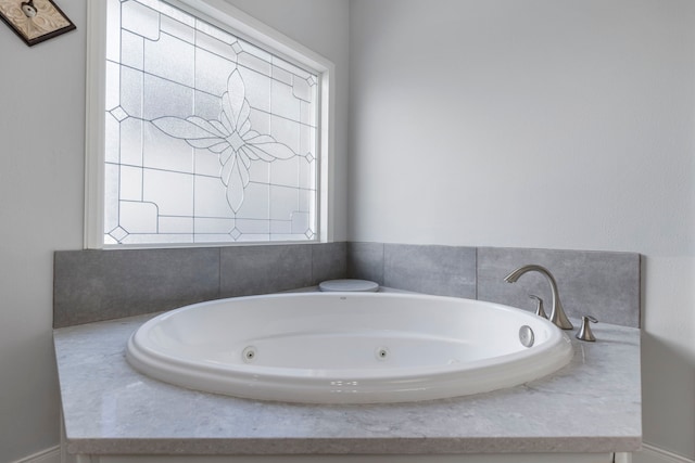 bathroom featuring tiled tub