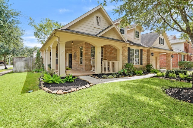 view of front of house featuring a porch and a front lawn