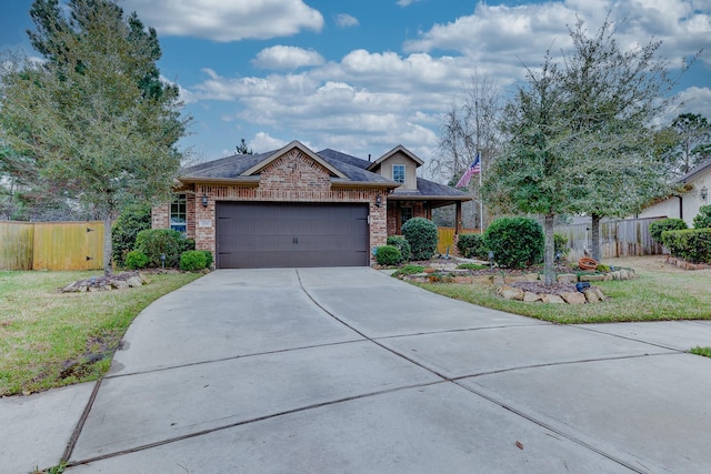 single story home featuring an attached garage, fence, concrete driveway, and brick siding