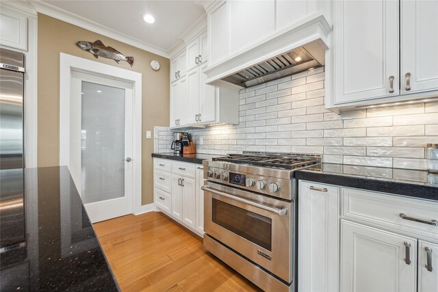 kitchen with stainless steel appliances, custom exhaust hood, and white cabinets