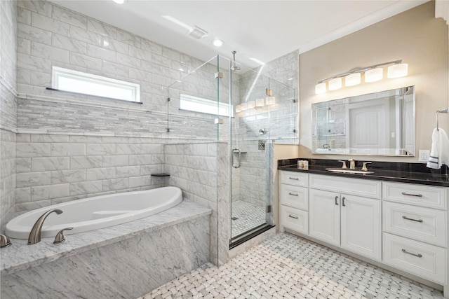 bathroom with vanity and independent shower and bath