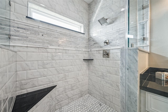 bathroom with tiled shower