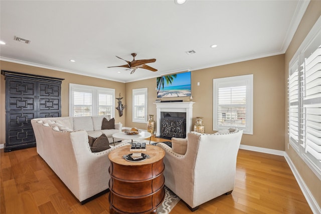 living room featuring crown molding, ceiling fan, and wood-type flooring