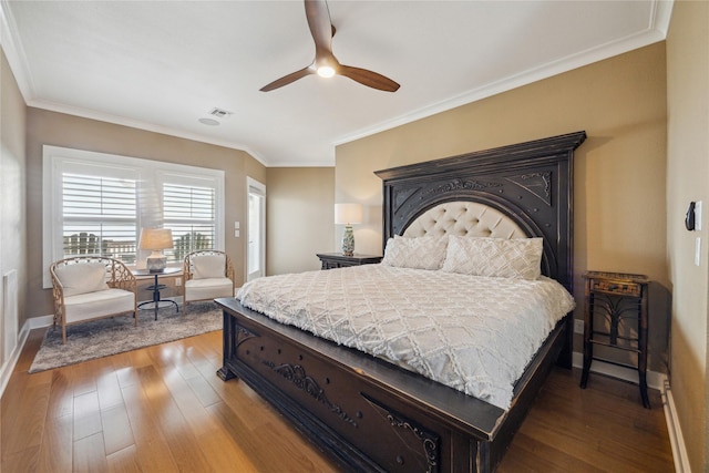 bedroom with hardwood / wood-style flooring, ceiling fan, and crown molding