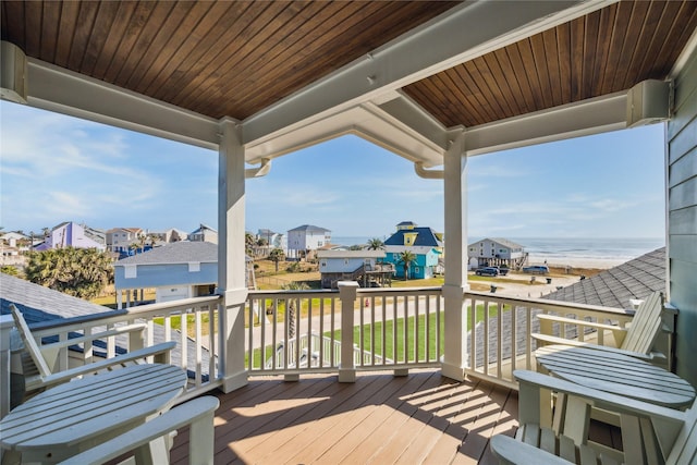 wooden terrace featuring a water view