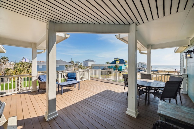 wooden terrace with a playground and a water view