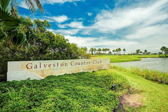community / neighborhood sign with a water view