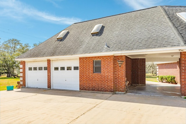 view of side of property featuring an outbuilding and a garage