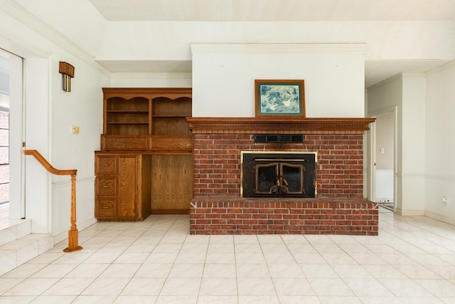 unfurnished living room with crown molding, light tile patterned flooring, and a fireplace