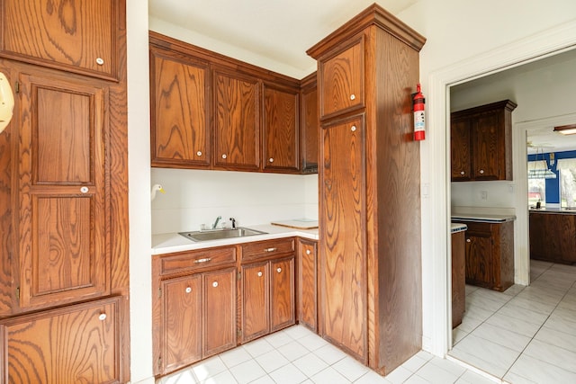 kitchen featuring light tile patterned flooring and sink