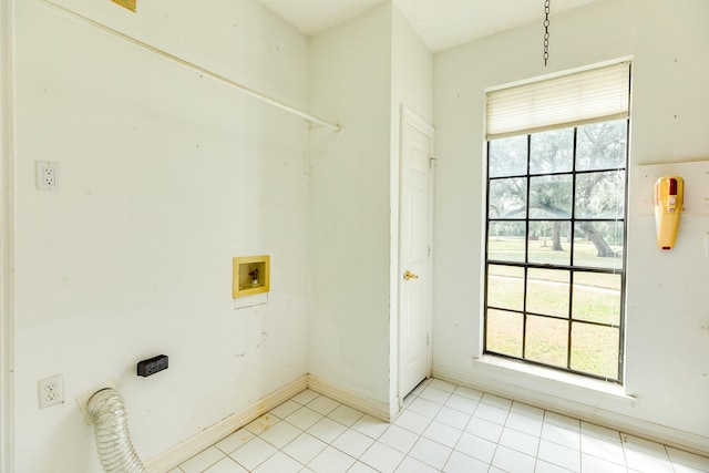 washroom with washer hookup and light tile patterned floors