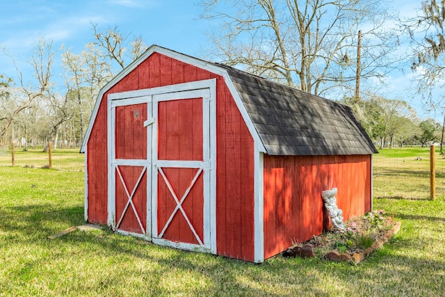 view of outbuilding featuring a yard