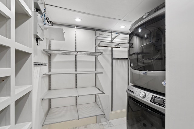 interior space featuring stacked washer and clothes dryer