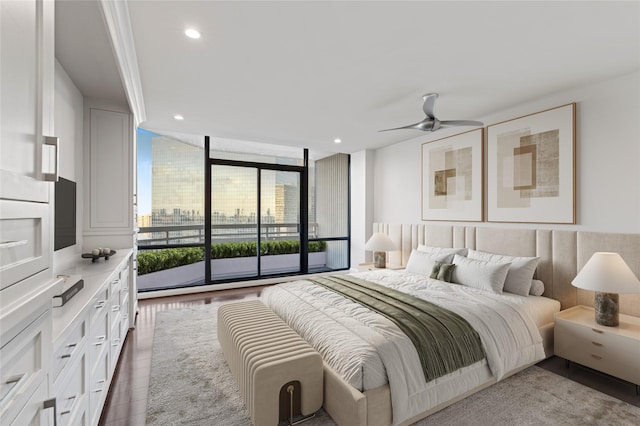 bedroom with wood-type flooring and expansive windows