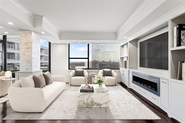 living room with built in features, crown molding, and dark hardwood / wood-style flooring