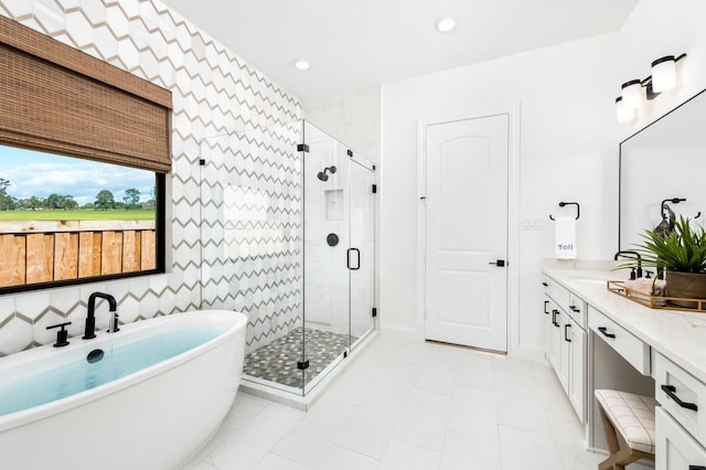 bathroom with vanity and separate shower and tub