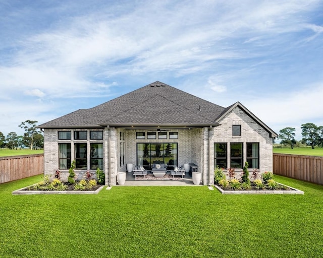 back of property with a lawn and a patio