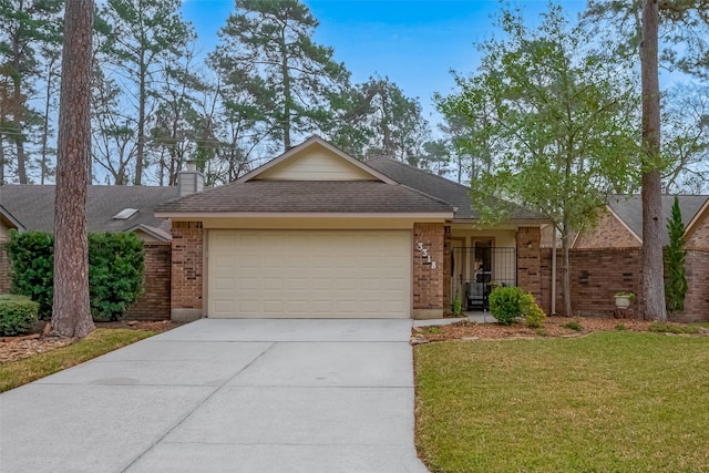 single story home with an attached garage, brick siding, concrete driveway, a chimney, and a front yard