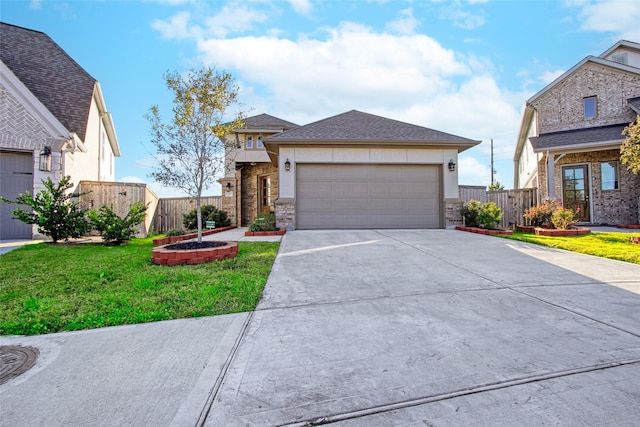 view of front of property featuring a garage and a front yard