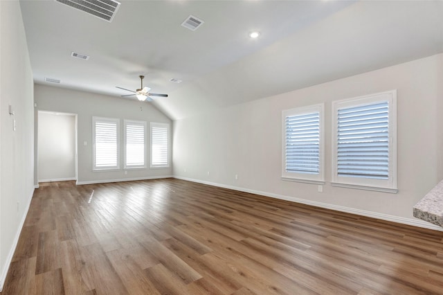 empty room featuring vaulted ceiling, ceiling fan, and light hardwood / wood-style flooring