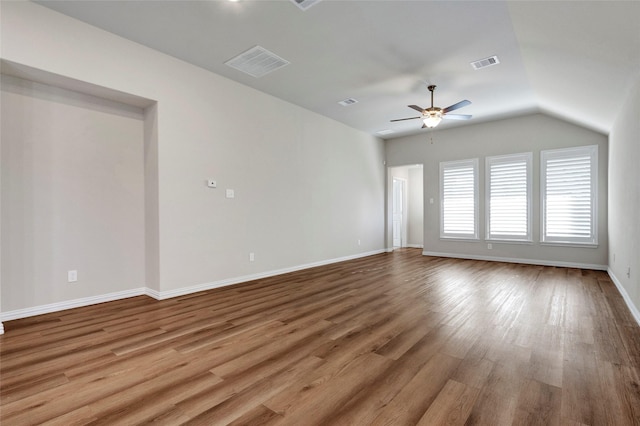 spare room featuring ceiling fan, vaulted ceiling, and light wood-type flooring