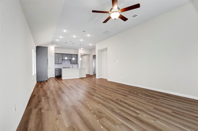 unfurnished living room with light hardwood / wood-style flooring and ceiling fan