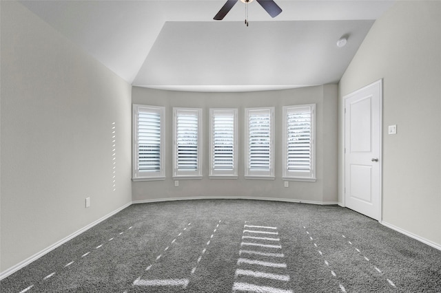 carpeted empty room featuring ceiling fan and vaulted ceiling