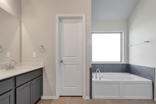 bathroom with vanity, a bathing tub, and tile patterned flooring