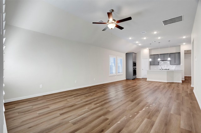 unfurnished living room with ceiling fan, lofted ceiling, and light hardwood / wood-style floors