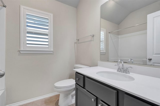 bathroom with vanity, plenty of natural light, tile patterned floors, and toilet