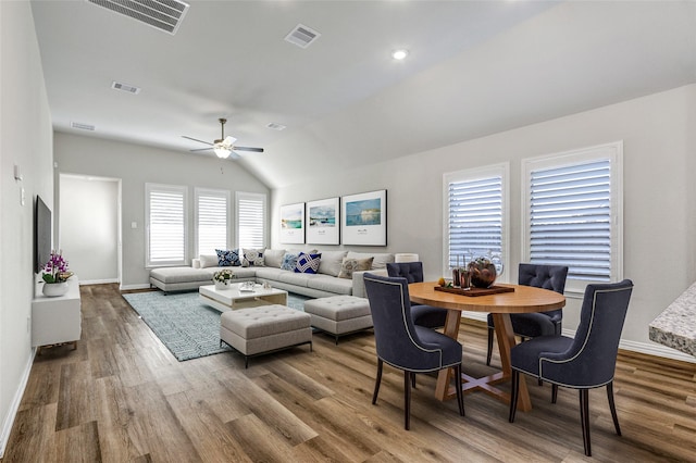 living room featuring hardwood / wood-style flooring, vaulted ceiling, and ceiling fan