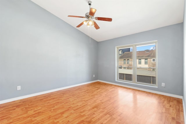 unfurnished room with light wood-type flooring, ceiling fan, lofted ceiling, and baseboards