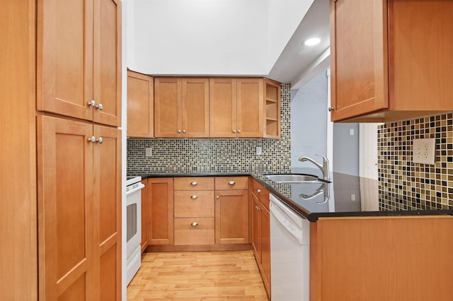 kitchen with brown cabinetry, white dishwasher, open shelves, and a sink