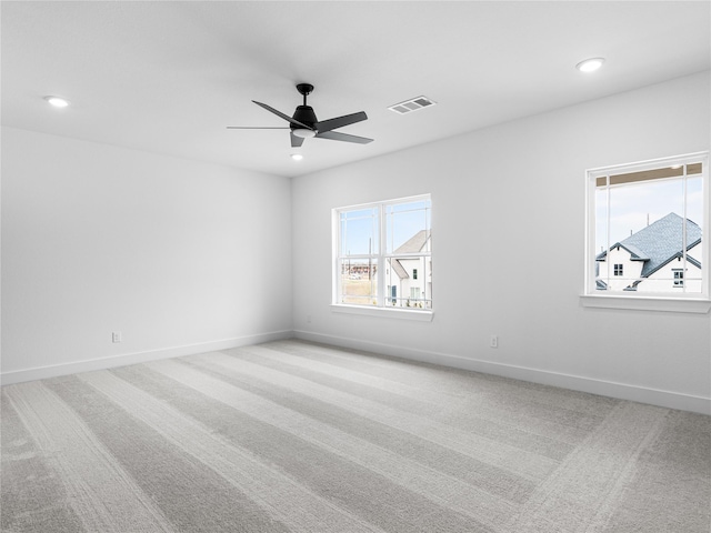 carpeted spare room with ceiling fan