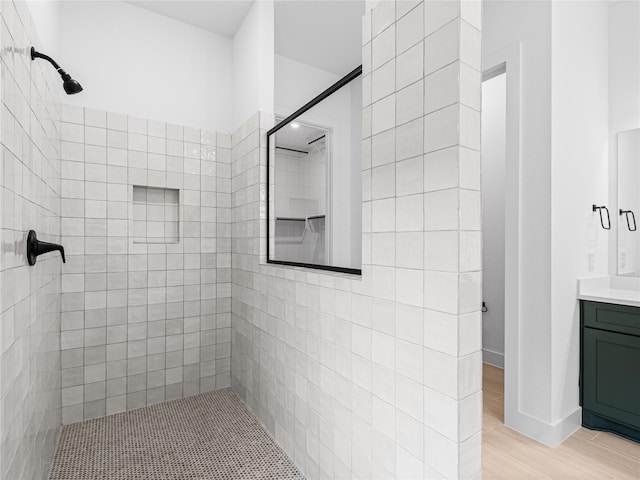 10914 Prospect Hill Ct, Missouri City, TX 77459 - full bath with a tile shower, vanity, and wood finished floors