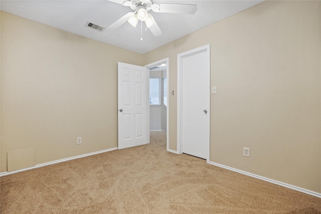 unfurnished room featuring light carpet and ceiling fan