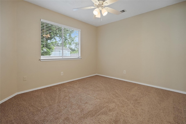 carpeted spare room with ceiling fan