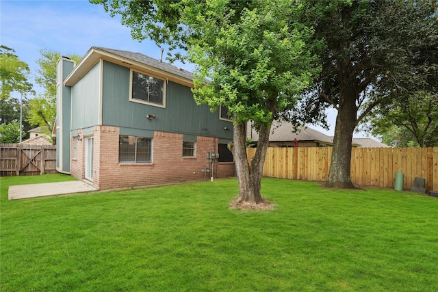 rear view of property with a yard