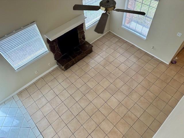 living room with ceiling fan and light tile patterned flooring