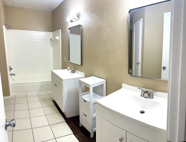 bathroom featuring vanity, bathtub / shower combination, and tile patterned flooring