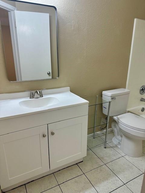 full bathroom with vanity, tile patterned floors, shower / bathtub combination, and toilet