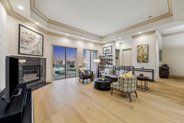 3388 Sage Rd Unit 2401, Houston, TX 77056 - living area featuring a tray ceiling, light wood-style floors, crown molding, a high end fireplace, and recessed lighting