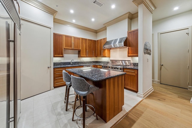 3388 Sage Rd Unit 2401, Houston, TX 77056 - kitchen featuring wall chimney range hood, a sink, stove, crown molding, and a kitchen island