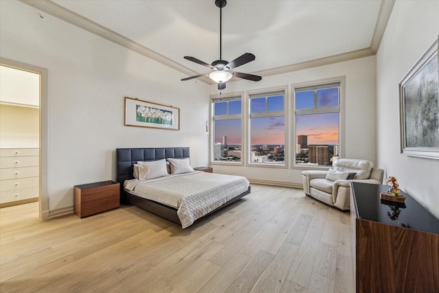 3388 Sage Rd Unit 2401, Houston, TX 77056 - bedroom featuring ornamental molding, light wood-type flooring, baseboards, and a ceiling fan