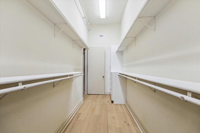 3388 Sage Rd Unit 2401, Houston, TX 77056 - walk in closet with light wood-type flooring