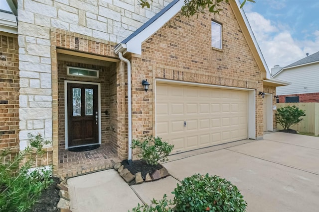 doorway to property with a garage