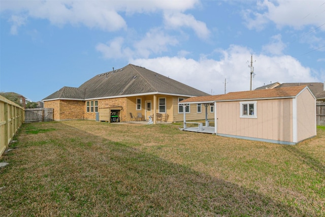 rear view of house featuring a yard, a fireplace, and a patio area